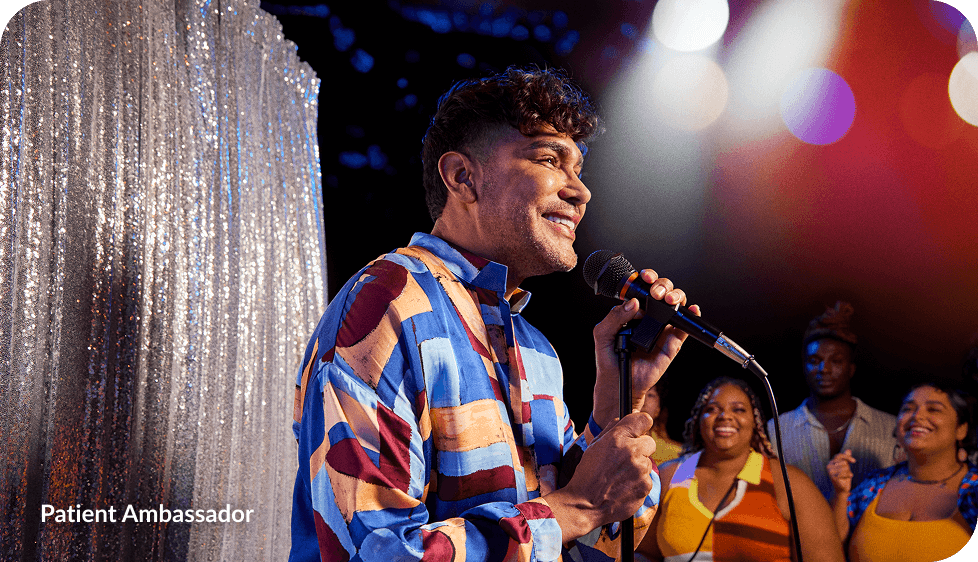 Jorge on stage with a microphone